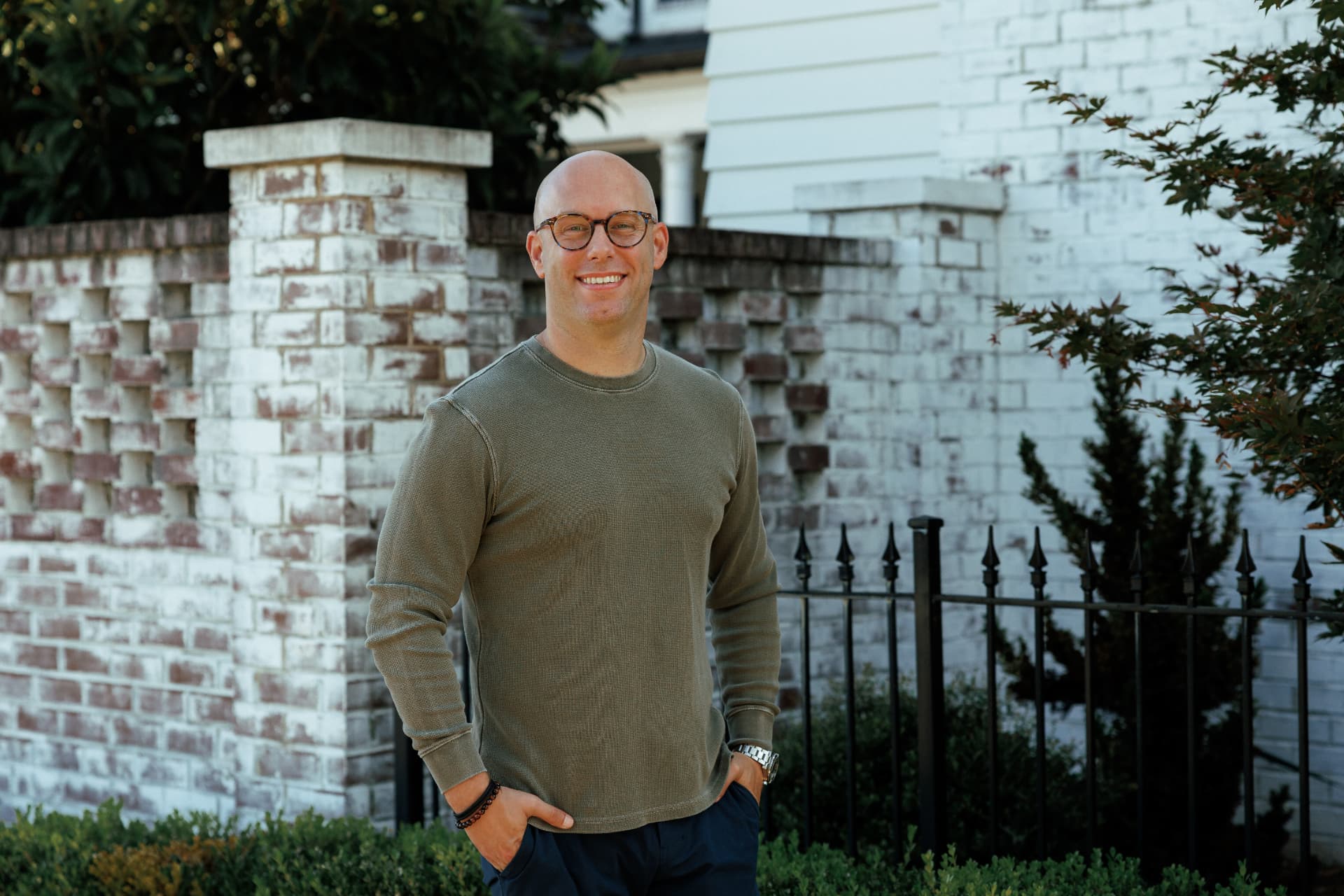 Zach Barnett standing by a brick wall